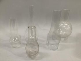 Five Victorian glass chimneys of varying sizes