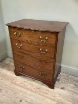 An early 20th century bow fronted mahogany chest of four long drawers by Hampton's of London, 77cm x