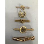 Five early 20th. century bar brooches all in 9ct gold with various themed designs some with later