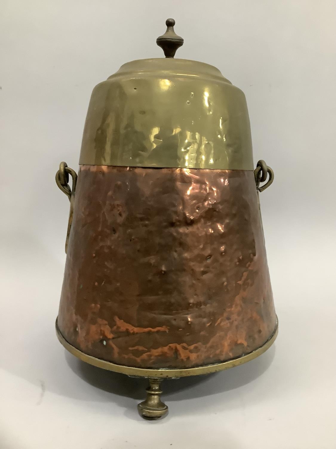 Dutch copper and brass doofpot with brass lid and finial, swing handle on raised feet 44cm high