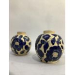 A pair of studio pottery earthenware vases of ovoid form with patches of blue glaze in the form of