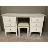 A white twin pedestal dressing table having six short drawers, on square feet together with stool,