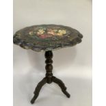 A Victorian papier mache tripod table the top inlaid with mother of pearl and having floral
