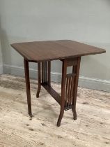 An Edwardian mahogany Sutherland table with drop leaves