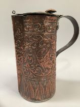 A copper secessionist style lidded jug, the body moulded in heavy relief with trailing foliage and a