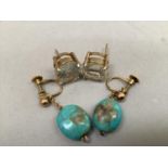 A pair of early 20th. century turquoise ear pendants in 9ct. gold, each matrix pebble bead hung on a