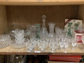A large quantity of glass ware including cut glass trifle dishes, fruit bowls, two decanters, two