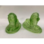 A pair of John Derbyshire moulded green glass lions in recumbent posh on bases bearing anchor and