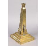 A Victorian brass lamp base formed as Cleopatra's needle bearing inscription to stepped base, ‘