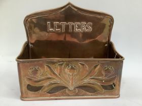 Keswick school style copper letter rack, with plannished and pierced decoration and relief moulded