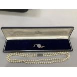 A cultured pearl necklace approx 5.5mm size strung in two rows fastened with a silver marcasite