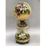 A 19th century American double globe hand painted oil lamp, with orb shade and brass reservoir,