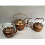 Three 19th century copper kettles of varying sizes including one with glass handle