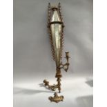 A gilt wood girandole with twin sconces, having panelled mirror back, with foliate beading and