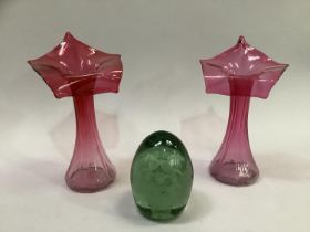 A pair of flared fluted slender neck cranberry vases with flared rims, 20cm high together with a