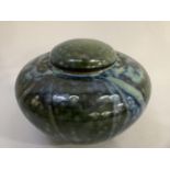 Studio pottery ginger jar and cover, in a metallic glaze of greens and blues, incised to base,