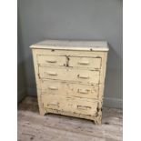A mid century cream painted chest of two short above three long drawers on bracket feet, 90cm wide