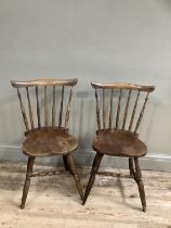 A pair of elm spindle back kitchen chairs on turned legs