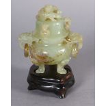 A Chinese carved hardstone incense burner and cover of pale green colour, the domed cover with