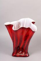 A glass vase of Fazzoletto form the exterior in reds and oranges with white interior, the glass