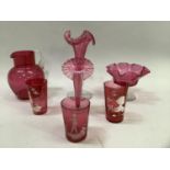Two Mary Gregory style cranberry beakers hand painted with a silhouette of a woman and a child in