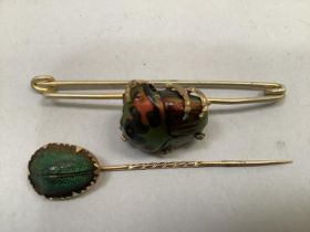 A 19th. century tropical beetle brooch, the polly chrome carapace set in leg-like claws to the