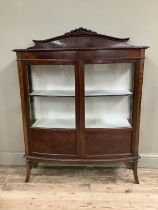 An Edwardian mahogany double bow fronted cabinet with glazed doors over three internal shelves,