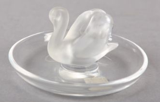 A Lalique glass trinket dish with frosted glass swan raised to the centre, signed Lalique, France to