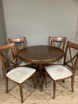 A G-Plan extending round top dining table with tripod base and four cross back chairs