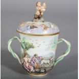 An Italian porcelain cup and cover moulded and enamelled in the Naples manner with classical figures