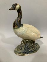 Cast sculpture of a Canada Goose on a naturalistic base, 29cm high