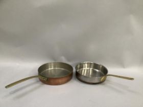 Two copper saute pans with brass handles, 23.5cm and 24cm diameter, possibly French