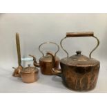 A large 19th century copper kettle together with another two smaller and a copper posser stamped