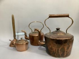 A large 19th century copper kettle together with another two smaller and a copper posser stamped