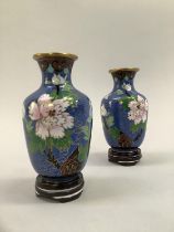 Pair of cloisonne vases of ovoid form, enamelled in blue with white flowers and birds on carved