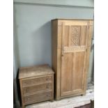 A limed oak gentleman's wardrobe 80cm wide, of single carved door on bracket feet together with