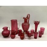 Quantity of 19th and 20th century cranberry glass including gilt ewer, jug with clear handle, vase