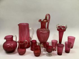 Quantity of 19th and 20th century cranberry glass including gilt ewer, jug with clear handle, vase