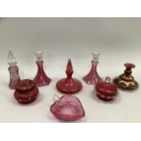 Pair of cranberry glass candle sticks and a matching scent bottle, another scent bottle, gilt candle