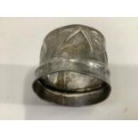 A mid 20th. Century Japanese silver napkin ring signed "Musashinya" with bamboo chasing, approx