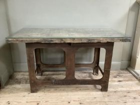 A reclaimed industrial table, having a pine and glass top on steel supports, 140cm x 70.5cm