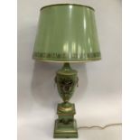 An Italian pale green toleware table lamp, of urn form with twin lion head masks with ring pull
