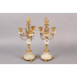 Pair of gilt and alabaster four light candelabras, foliage sconces supported by scrolled arms with