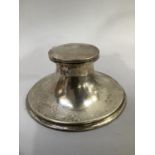 A George V silver ink well, circular with weighted stepped foot, approximate diameter 14cm