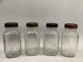 Four vintage storage jars with bakelite lids