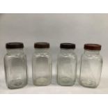 Four vintage storage jars with bakelite lids