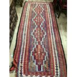 Afghan tribal rug, having three lozenge medallions on a blue field within red and cream border edged
