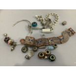 Four bracelets all in white metal (Tests as silver) variously set with glass beads, enamel and