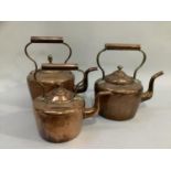 Three 19th century copper kettles of varying sizes