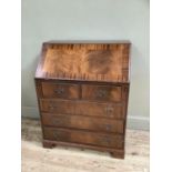 A reproduction mahogany veneered bureau with drop down compartment the lid inlaid with leather inset